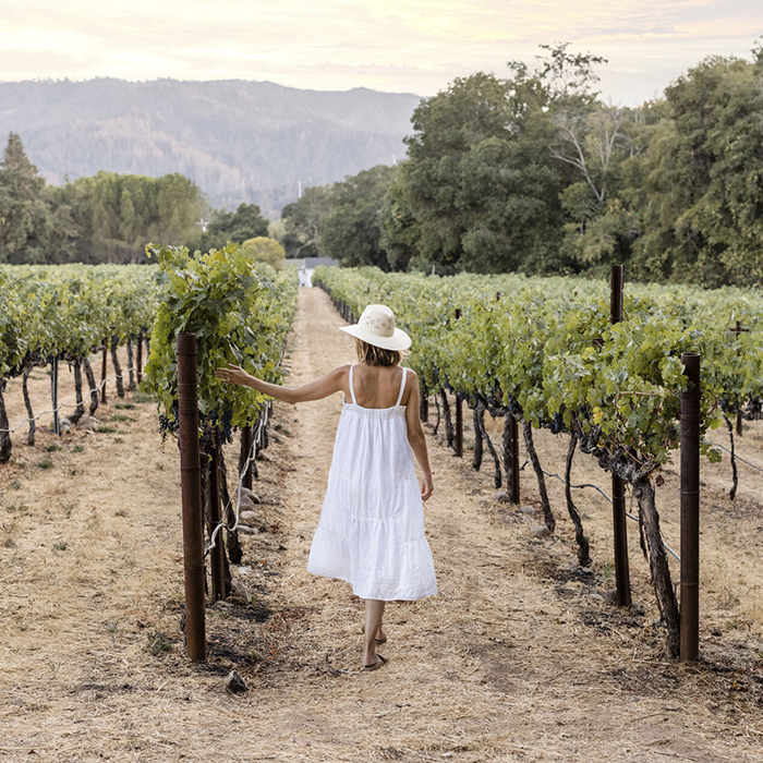 A woman walking in the vineyards of a hotel resort